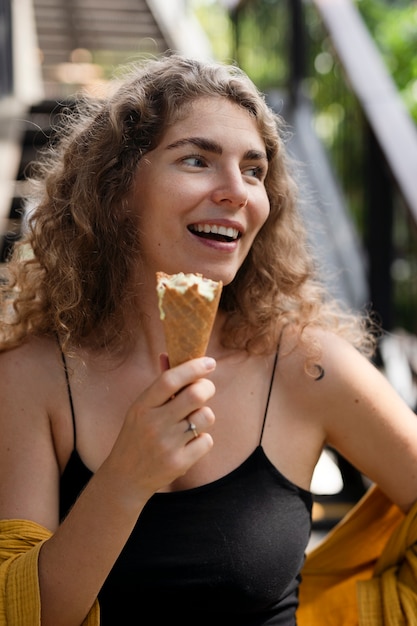 Young woman eating ice cream cone