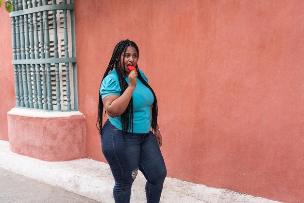 Young woman eating ice cream on the street in Cartagena