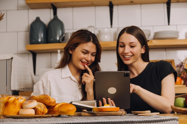 Young woman eating pizza and laughing while sitting with her friends in a restaurant Group of friends enjoying while having food and drinks at cafe