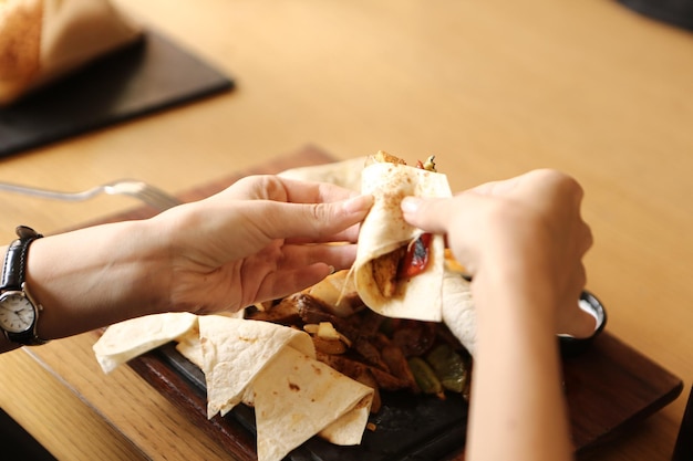 A young woman eats a tasty fresh Indian meals