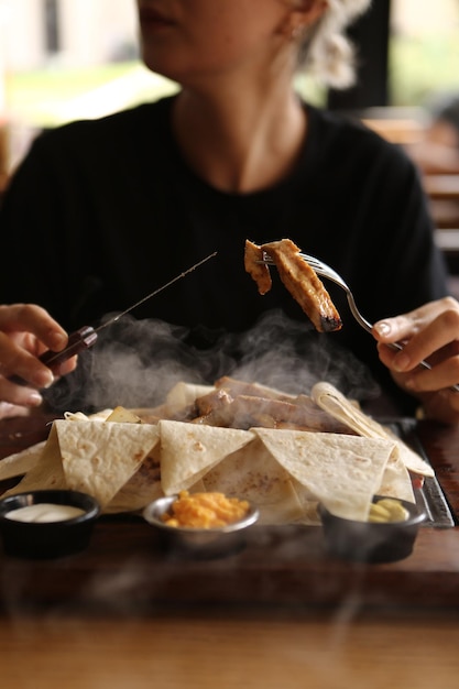 A young woman eats a tasty fresh Indian meals