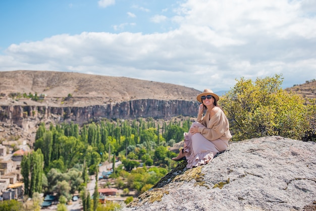 Young woman on the edge of canyon in cappodocia