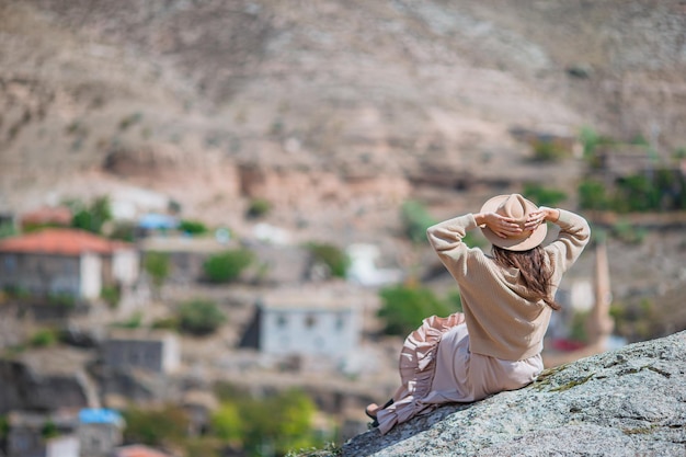 Young woman on the edge of canyon in cappodocia