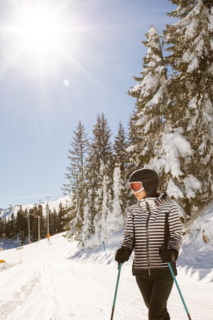 Young woman enjoing winter day of skiing fun in the snow