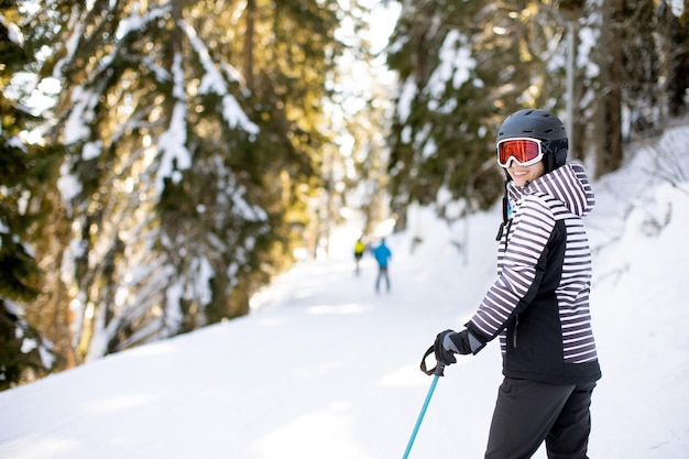 Young woman enjoing winter day of skiing fun in the snow