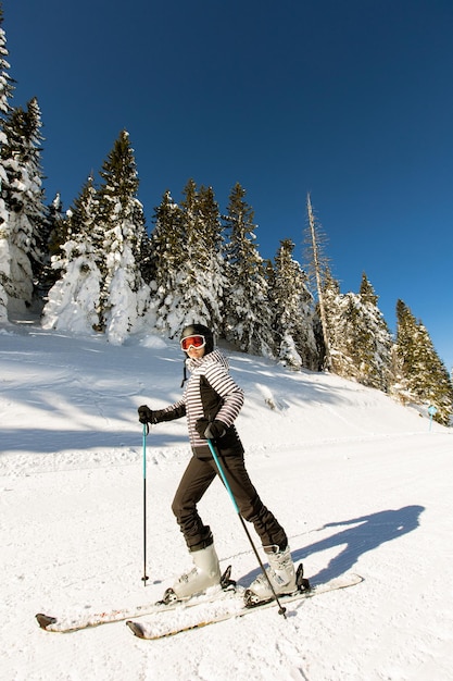 Young woman enjoing winter day of skiing fun in the snow