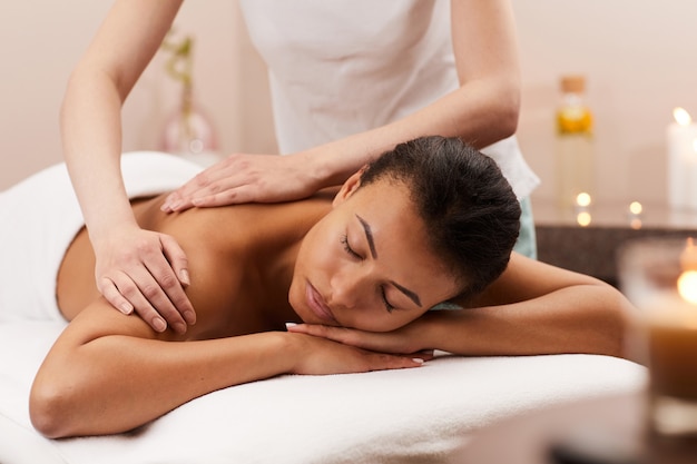 Young woman enjoying back massage