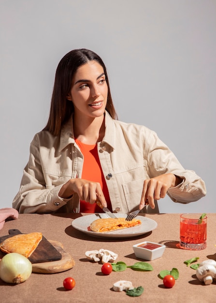 Young woman enjoying a delicious calzone pizza