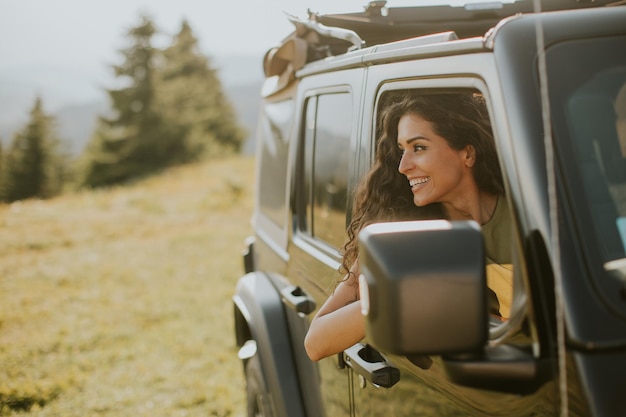 Young woman enjoying freedom in terrain vehicle on a sunny day