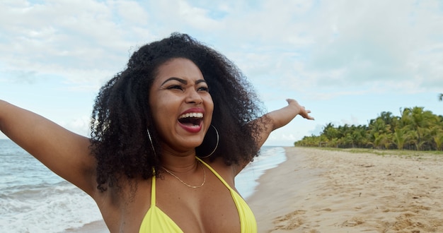 Young woman enjoying her summer vacation on a sunny day smiling and looking at the camera