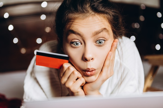 Young woman enjoying shopping online for Christmas.