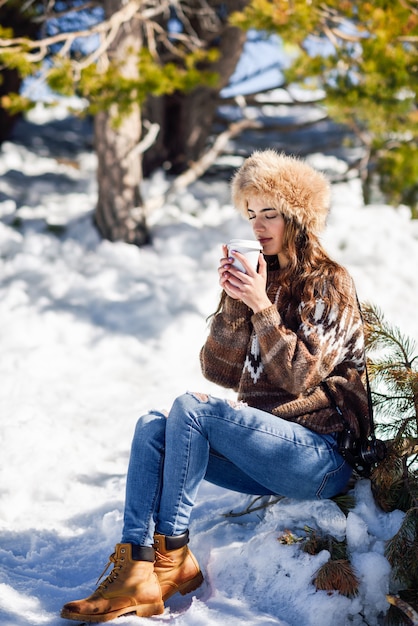 Young woman enjoying the snowy mountains in winter