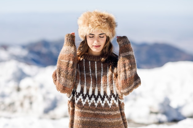 Young woman enjoying the snowy mountains in winter