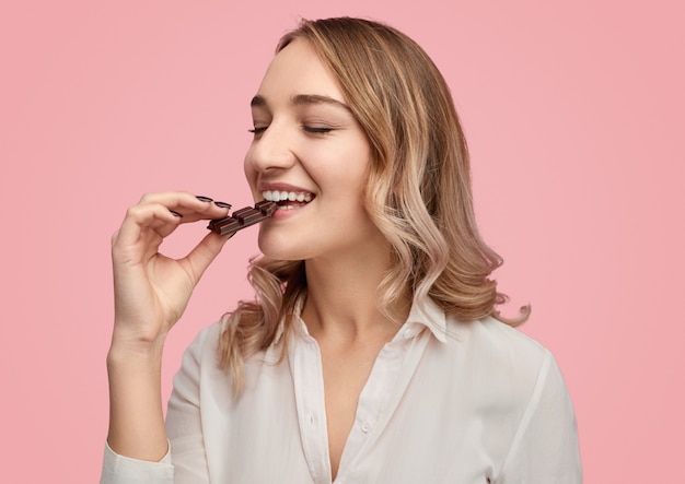 Young woman enjoying sweet chocolate