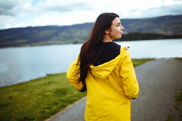 Young woman enjoys freedom against the backdrop of the mountains in the Norway The girl tourist