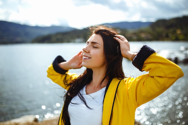 Young woman enjoys freedom against the backdrop of the mountains in the Norway The girl tourist