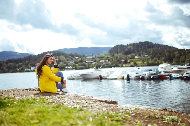 Young woman enjoys freedom against the backdrop of the mountains in the Norway The girl tourist