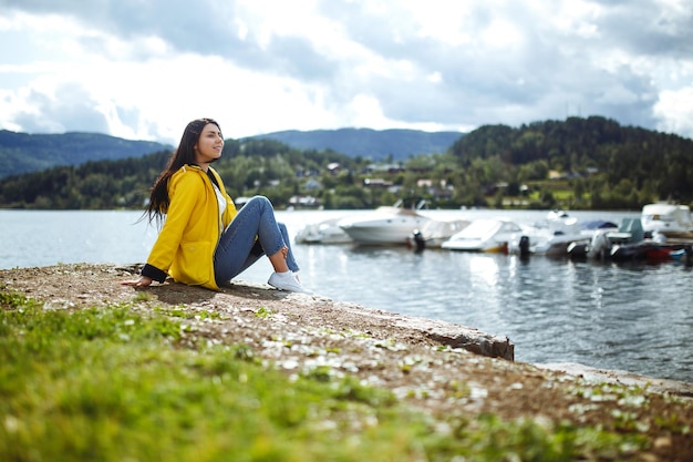 Young woman enjoys freedom against the backdrop of the mountains in the Norway The girl tourist