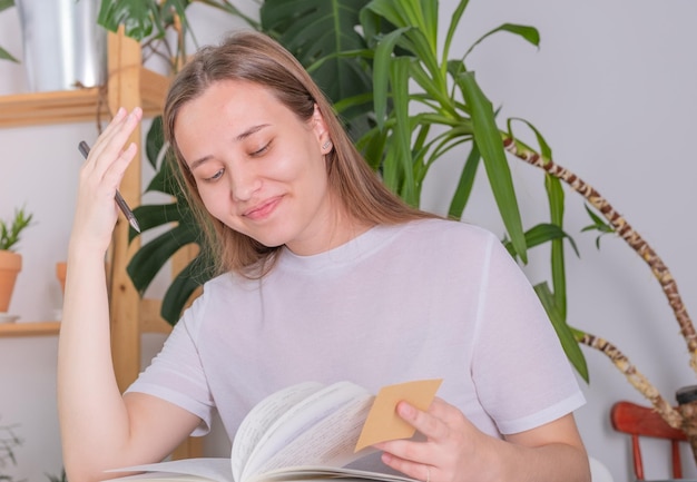 A young woman of European appearance does homework at school, university. The girl diligently studie