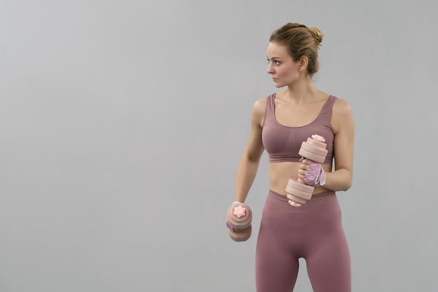 Young woman exercise using dumbbell to lose weight or burn calories Healthy life concept