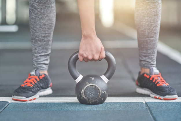 Young woman exercises in gym healthy lifestyle holding dumbbell