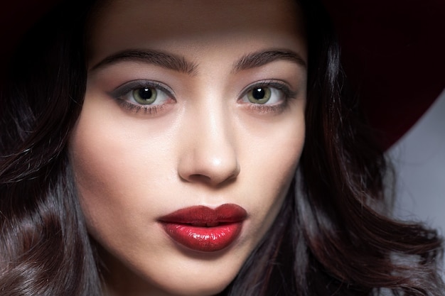 Young woman face with beautiful long dark hair.