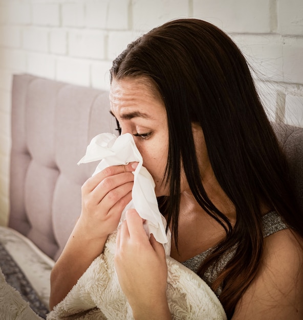 Young woman feeling sick indoors