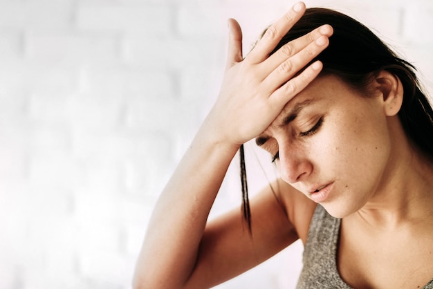 Young woman feeling sick indoors