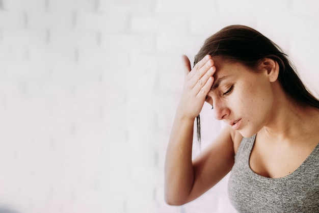 Young woman feeling sick indoors