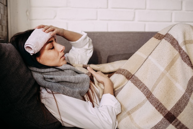 Young woman feeling sick sitting in bed