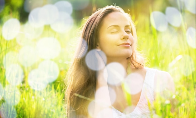 Young woman on field under sunset light