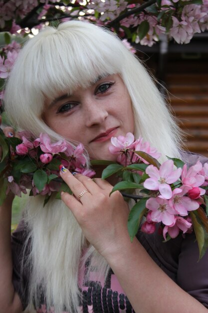 young woman in flower garden in spring. female portrait