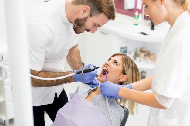 Young woman getting dental treatment in dentist office