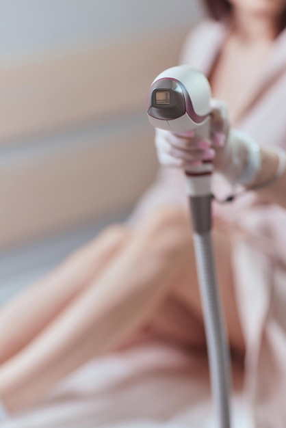 Young woman getting laser hair removal on her thighs