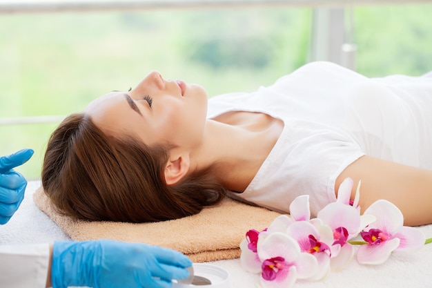 Young woman getting spa massage treatment at beauty spa salon