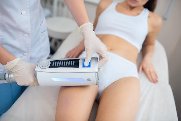 Young woman getting an ultrasound massage therapy