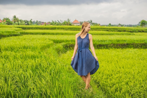 Young woman on Green cascade rice field plantation. Bali, Indonesia