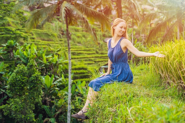 Young woman on Green cascade rice field plantation at Tegalalang terrace. Bali, Indonesia. with sunlight