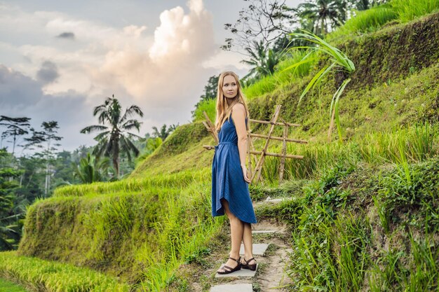 Young woman on Green cascade rice field plantation at Tegalalang terrace. Bali, Indonesia