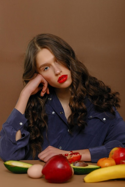 Young woman in group of fruit Healthcare and healthy nutrition concept Red lipstick