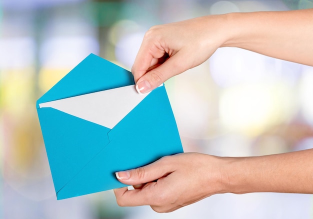 Young woman hands holding an envelope