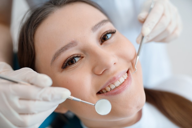 young woman having dental treatment at dentists office