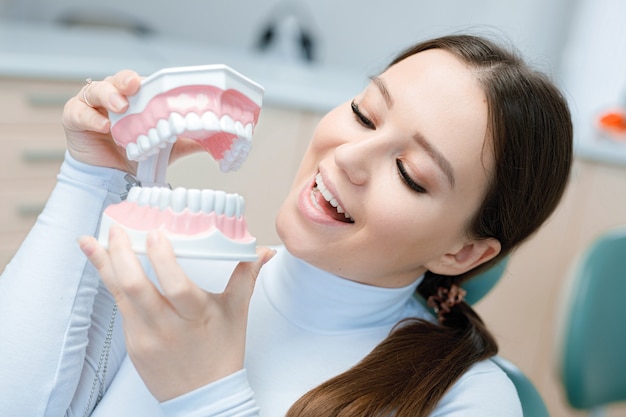 young woman having dental treatment at dentists office