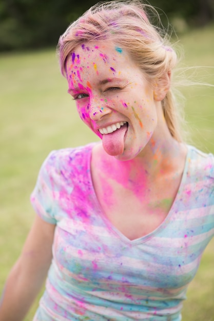 Young woman having fun with powder paint