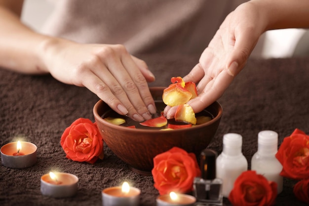 Young woman having hand treatment in spa salon