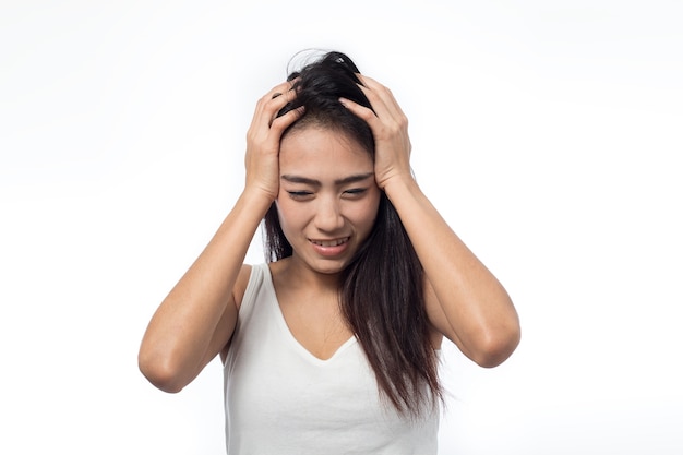 Young woman having headache on white