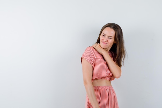 the young woman  having shoulderache on white background