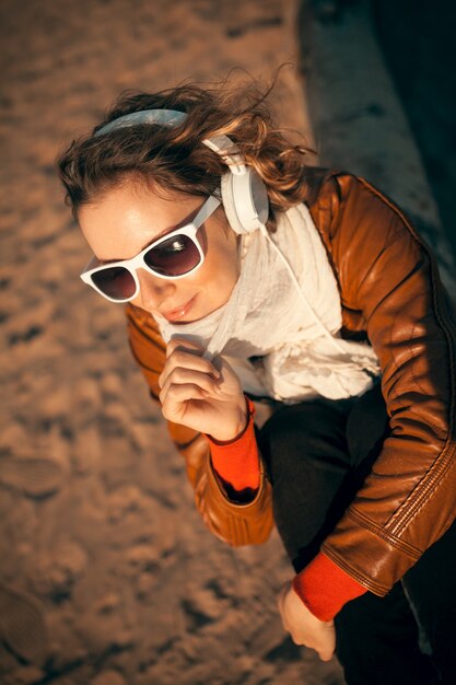 Young woman in a headphones at the beach