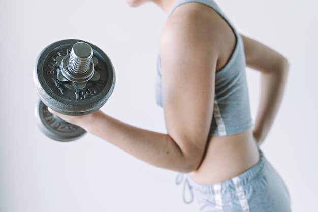 young woman do her series with vintage gym weights fitness concept