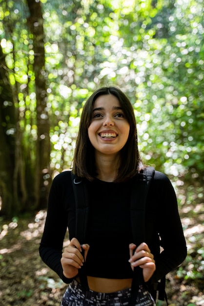 young woman hiker enjoying a day in the nature of the forest